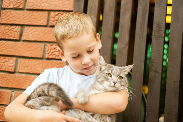 boy with type a diabetes with his cat in bed