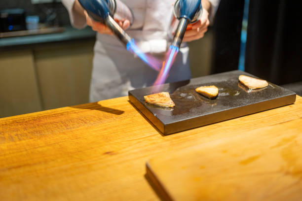 foie gras, foie gras appetizer with toasted wafers and dressings on a stone, tile or slate plate on wooden table