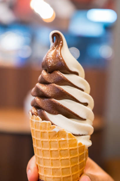 istock Soft serve ice cream of vanilla and chocolate on hand. 2164041801