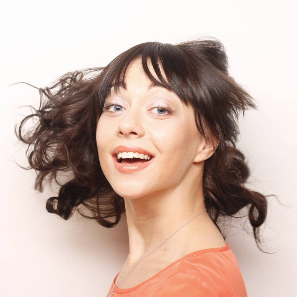 Young happy woman with wind in hair