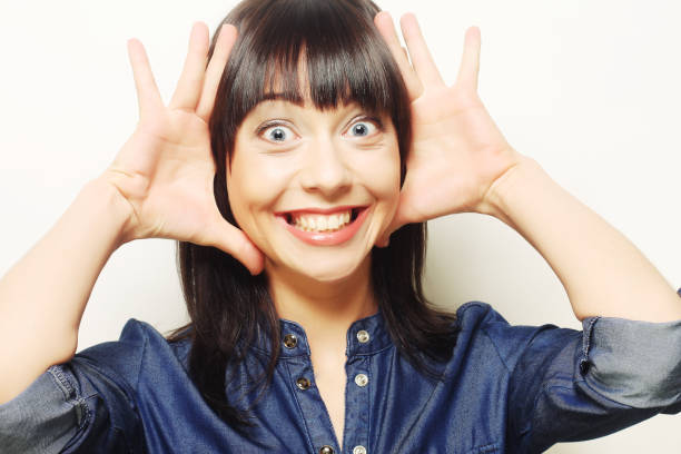 Beautiful young surprised woman. Studio shot.