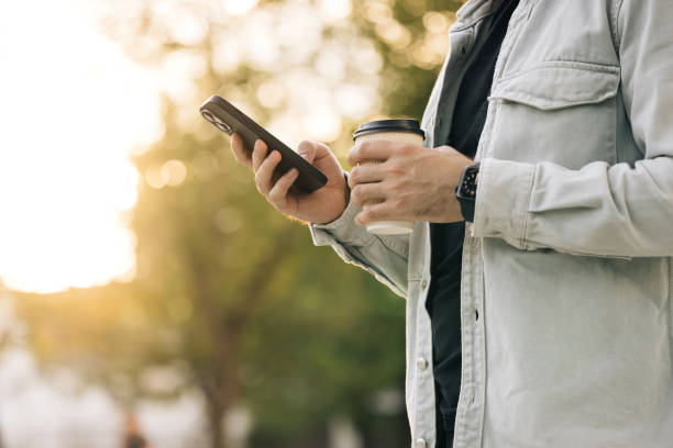 istock Unrecognizable male hands uses phone texting message, browsing surfinf internet tapping scrolling swipe up social media browsing isolated technology application 2164042758