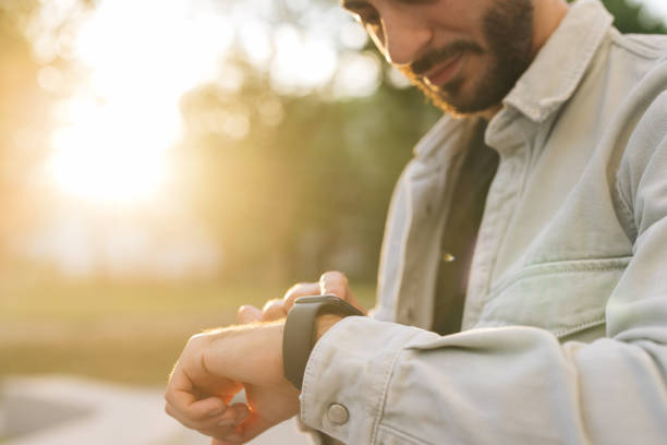 istock Touch Screen Wearable Technology Smart Band. Bearded Man Using Smart Watch Wearable Wristband Device. Male Checking Pulse Smartwatch App. Businessman Scrolling On Display On Smartwatch Notification 2164043172