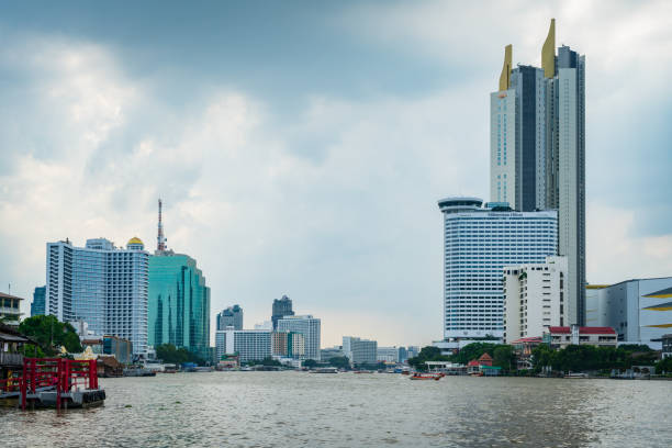 Bangkok, Thailand- 05 Nov. 2023: Chao Phraya River in urban area with large building on background.