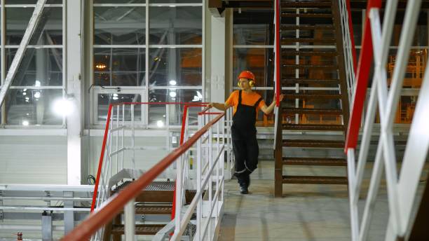 istock Equipment maintenance technician checks systems on production line at night. Ensuring smooth operations and preventing breakdowns. Dressed in safety gear, working diligently during night shift. 2164046309
