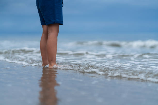 Latino boy from Cartagena Colombia, between 4 and 5 years old;  walking alone on the beach during a beautiful morning
