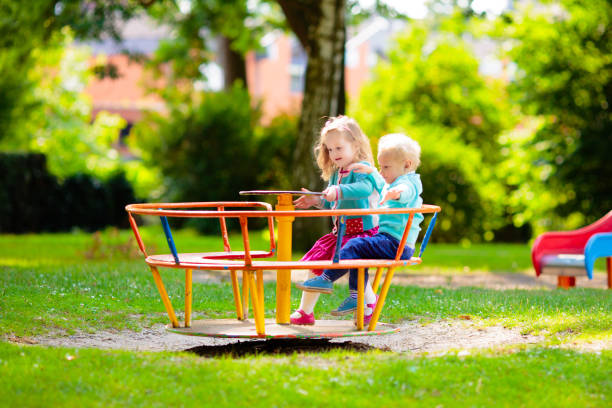 istock Kids explore nature. Children play in sunny park. 2164051775