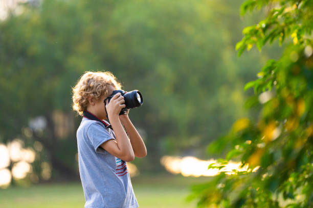 istock Child learning to take photos. Kid photographer. 2164052210