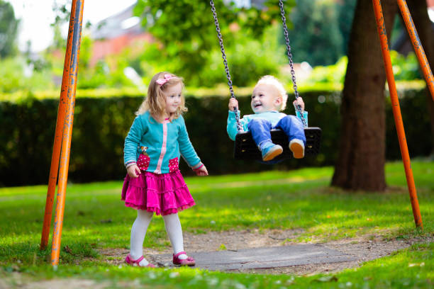 Kids explore nature. Children play in sunny park.