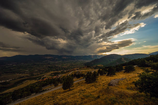a summer sunset over the mount Volturino with a cloudy skye in the background, Val D'Agri, Basilicata