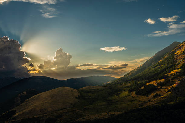 a summer sunset over the mount Volturino with a cloudy skye in the background, Val D'Agri, Basilicata