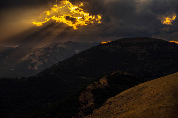 a summer sunset over the mount Volturino with a cloudy skye in the background, Val D'Agri, Basilicata