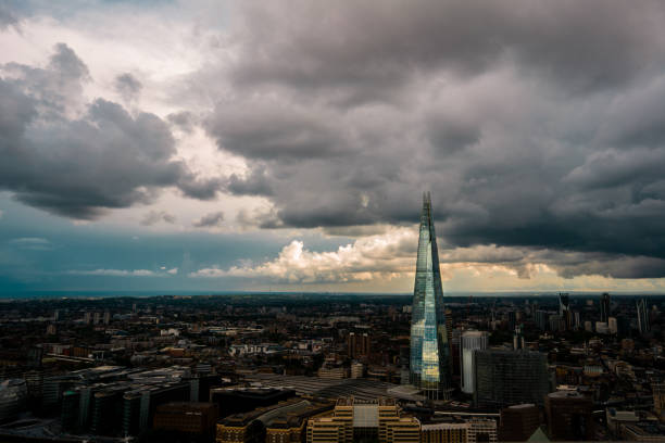 A moody picture of The Shard, London, with a dull shadow cast across the city skyline.