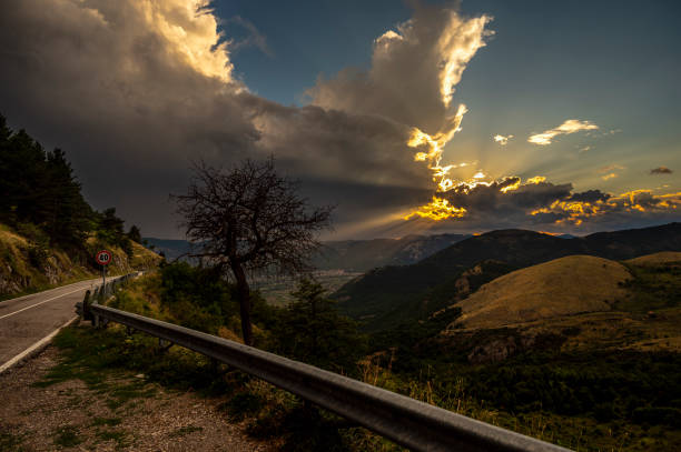 a summer sunset over the mount Volturino with a cloudy skye in the background, Val D'Agri, Basilicata