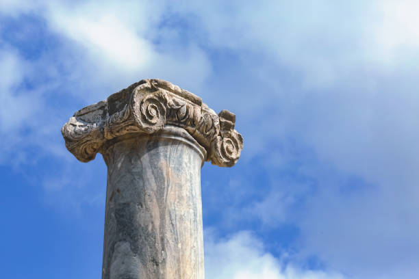 Ionic capital against a serene blue sky in Perge. Aksu, Antalya, Turkey (Turkiye)
