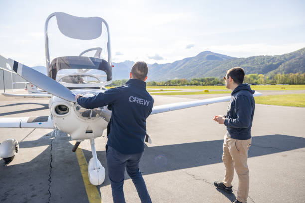 istock Ground Crew and Pilot Inspecting Light Aircraft 2164063829