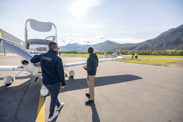 istock Ground Crew and Pilots with Light Aircraft at Airfield 2164064687