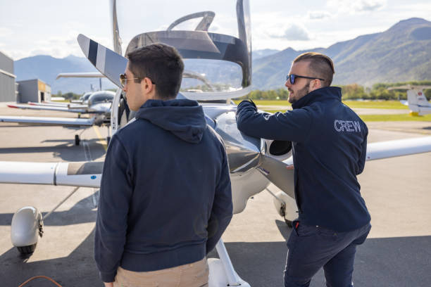 istock Ground Crew and Pilot Preparing Light Aircraft for Flight 2164064688