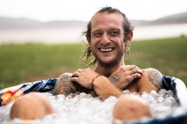 istock Man taking an ice bath in the middle of a field 2164065723