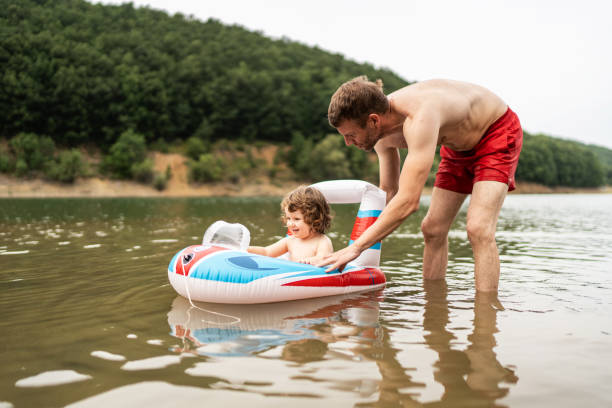 istock Father and little daughter having fun on the lake 2164067366