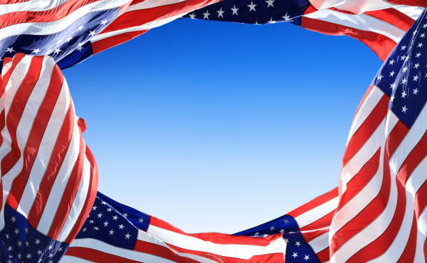 istock Close up American flags frame with copy space over blue sky 2164068493