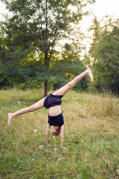 10-year-old gymnast practices in the garden
