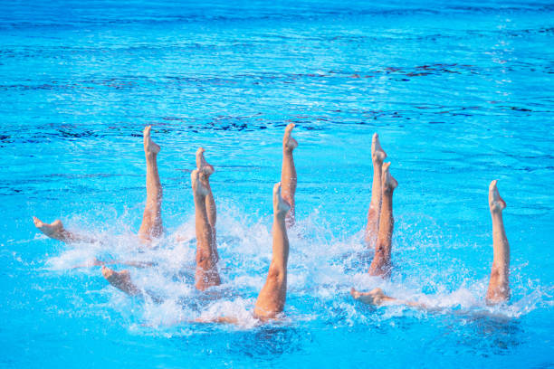 istock Synchronized female artistic swimming team performing synchronized legs movement in swimming pool 2164072228