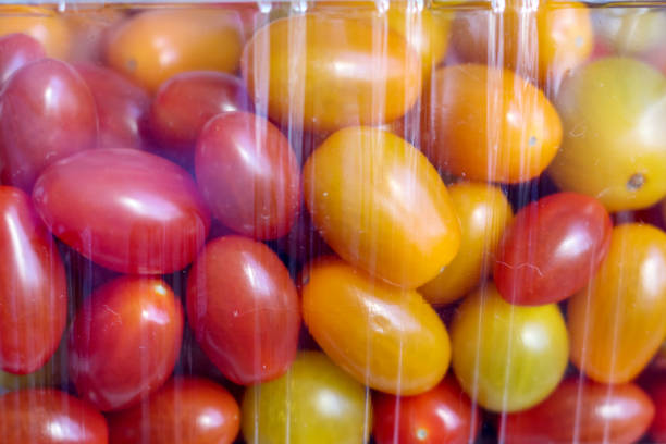 red and yellow tomato balls behind film packaging