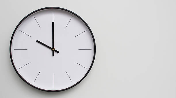 istock Wall Clock Showing O'Clock on White Wooden Surface - Perfect for Time Management and Scheduling Concepts 2164077349