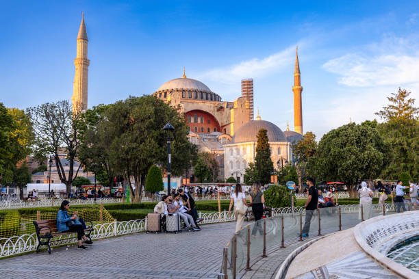 Istanbul, Tukiye. May 30th, 2024. Hagia Sophia at sunset, as seen from Sultan Ahmet Park with locals and torts near the fountain. UNESCO World Heritage Site