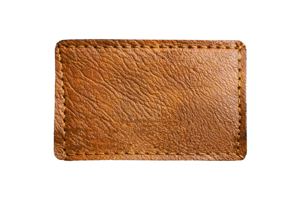 istock Brown leather belt strap closeup isolated on white. Brown titched leather seam frame label tag isolated on white. 2164078421