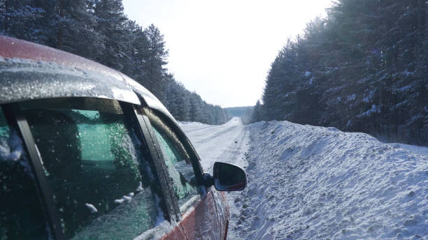 istock A red car stands on a snow-covered road 2164078845