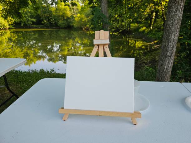 istock Painting canvas on easel with blank copy space in front of lake 2164079267