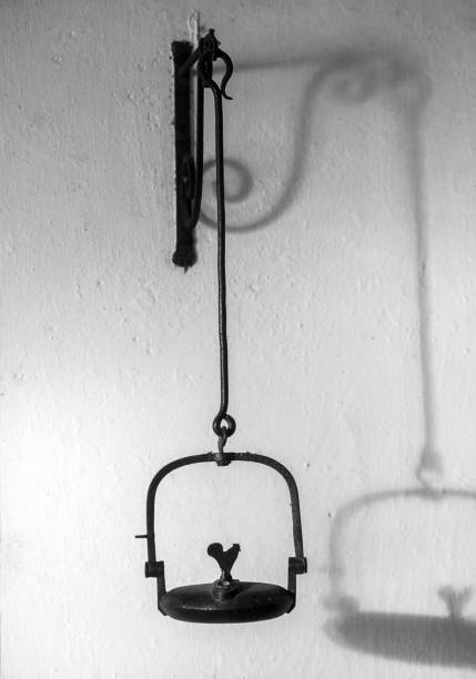 1800s miners lamp tunnel lantern iron cast hanging on a white wall