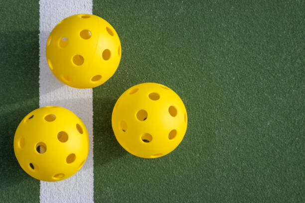 istock Three Pickleball balls on a court 2164081963