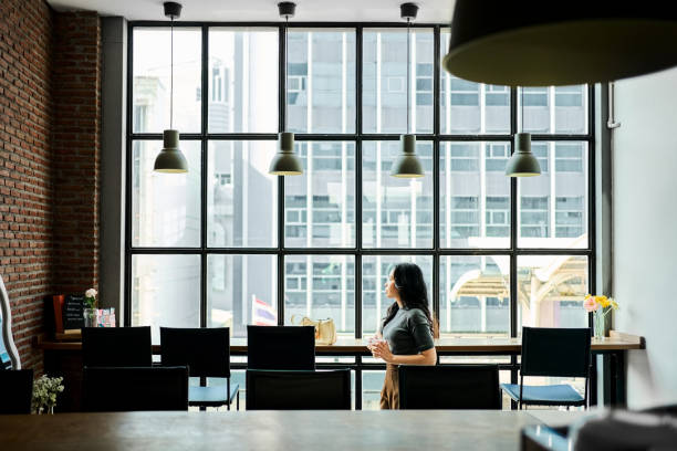 Contemplative female executive looking outside from cafe