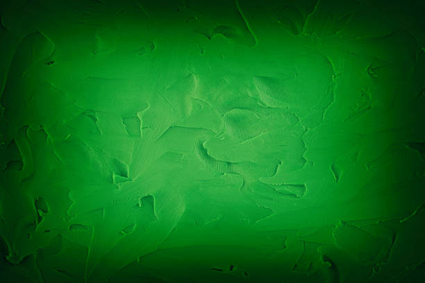 A background texture made out of green play clay. Close up.