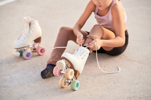istock Unrecognizable girl putting on roller skaters 2164086457