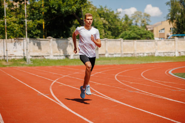 istock Young male athlete running on a track 2164100077