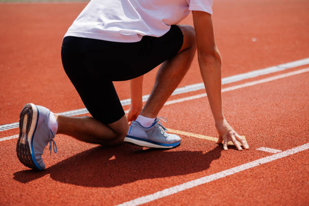 istock Athlete in starting position on running track 2164100097