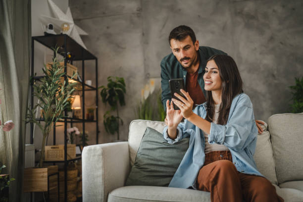 Wife navigate with cellphone her husband how to set cctv camera