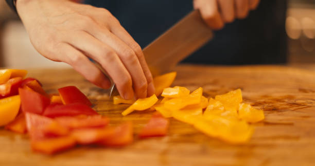 istock slicing a bell pepper on a wooden chopping board 2164104956