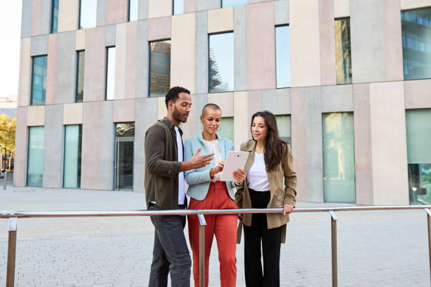 istock Serious multiethnic colleagues having business meeting with tablet 2164106841