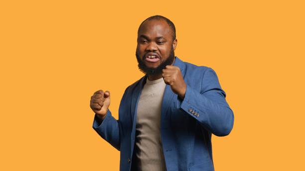 istock Man dancing from happiness, celebrating achievement, studio background 2164107053