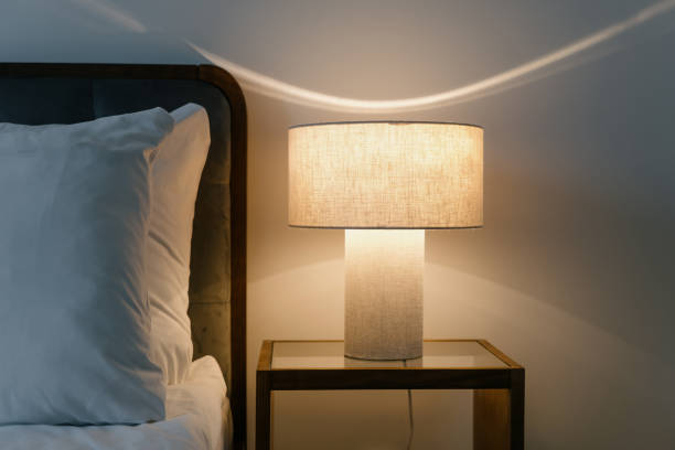 istock Bedroom interior with modern reading lamp on bedside table close to double bed with pillow 2164110269