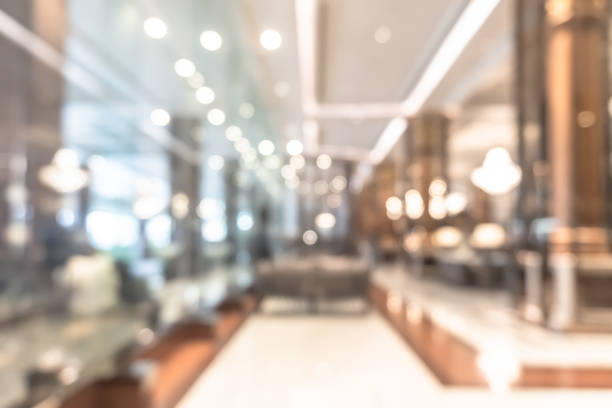 istock Blurred hotel or office building lobby blur background interior view with reception hall lounge, modern luxury white room space with blurry corridor and building glass wall window 2164115609