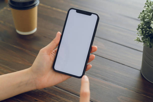 istock Hand holding smartphone mockup of blank screen for graphic display montage. 2164118012