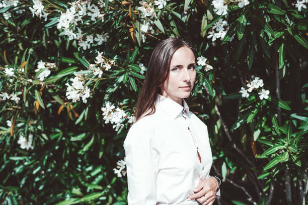 istock Woman by flowering bush 2164118066