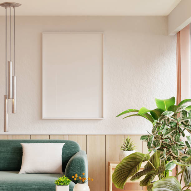 istock Mockup frame poster hanging on a white wall above a light green sofa, surrounded by various indoor plants in a cozy living room setting- 3D rendering 2164118844