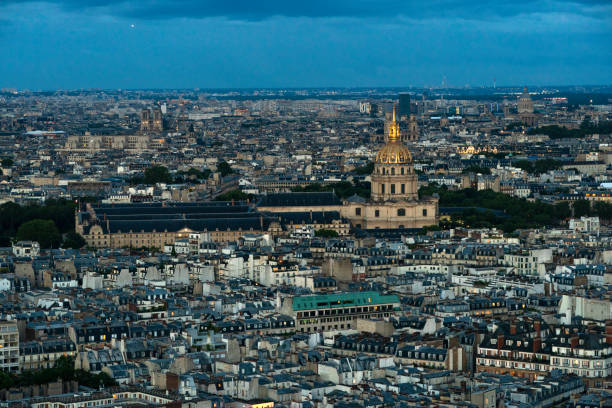 Paris, France - June 14, 2024:  Overview of Paris from the Eiffel Tower at night when buildings are illuminated.